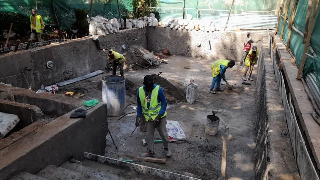 Workers building swimming pool