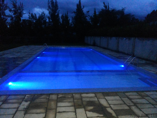 Pool lit with blue LED lighting at dusk