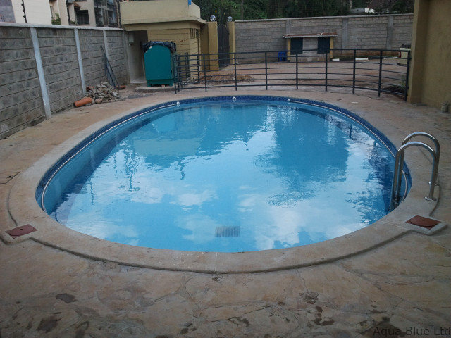 Oval swimming pool with chrome handrails