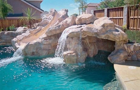 Grotto pool with a rock waterfall and slide