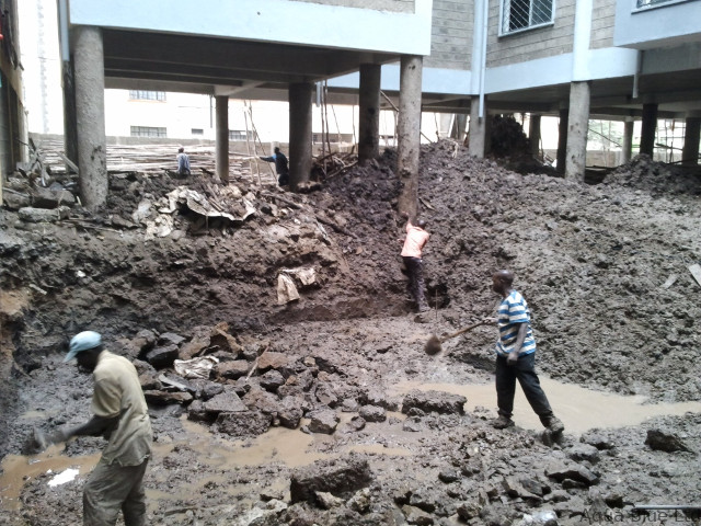 Excavation team working in the waterlogged pit